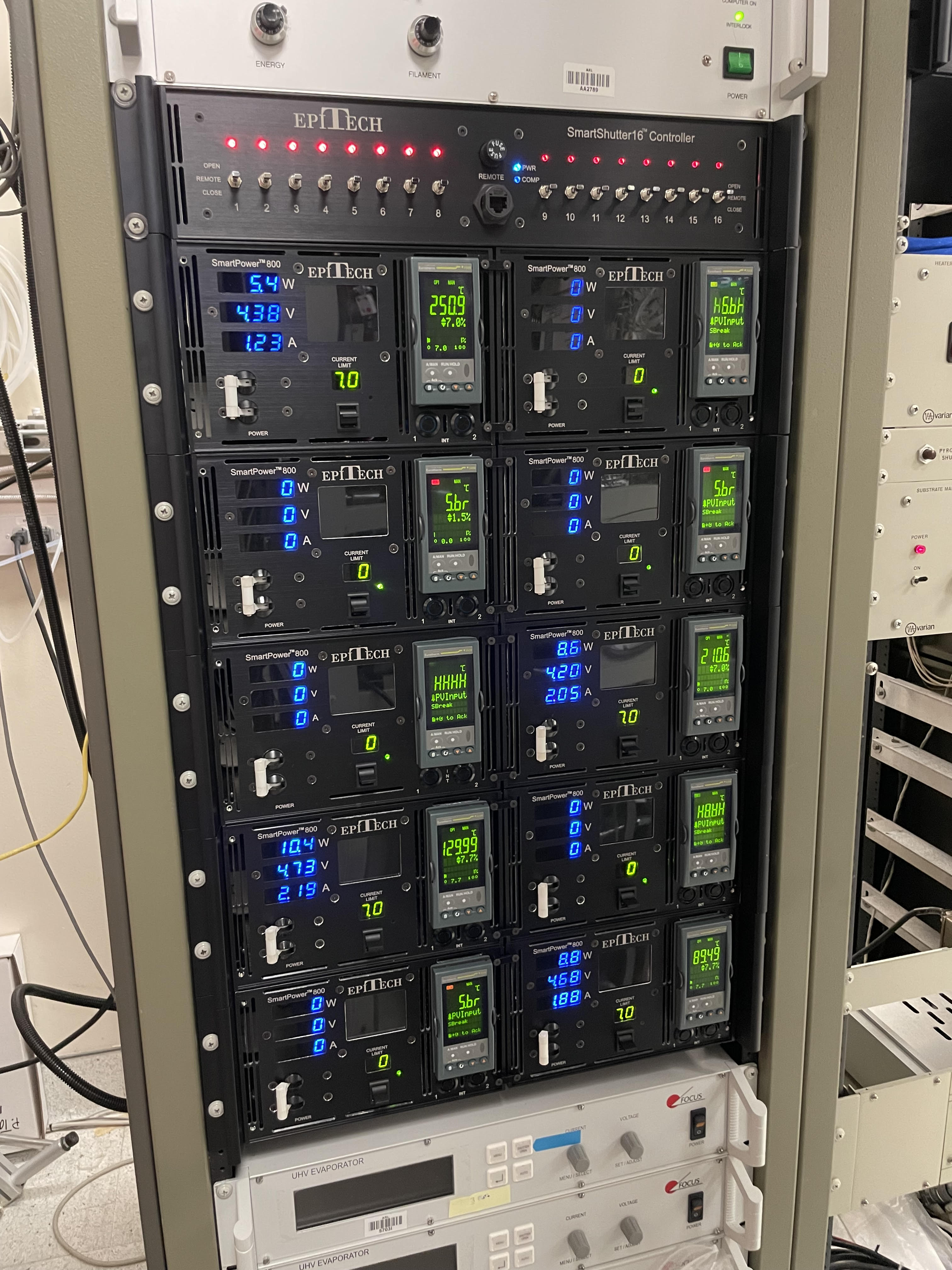 Ten EpiTech SmartPower 800 supplies in five rows beneath a SmartShutter16 controller in an MBE electronics rack